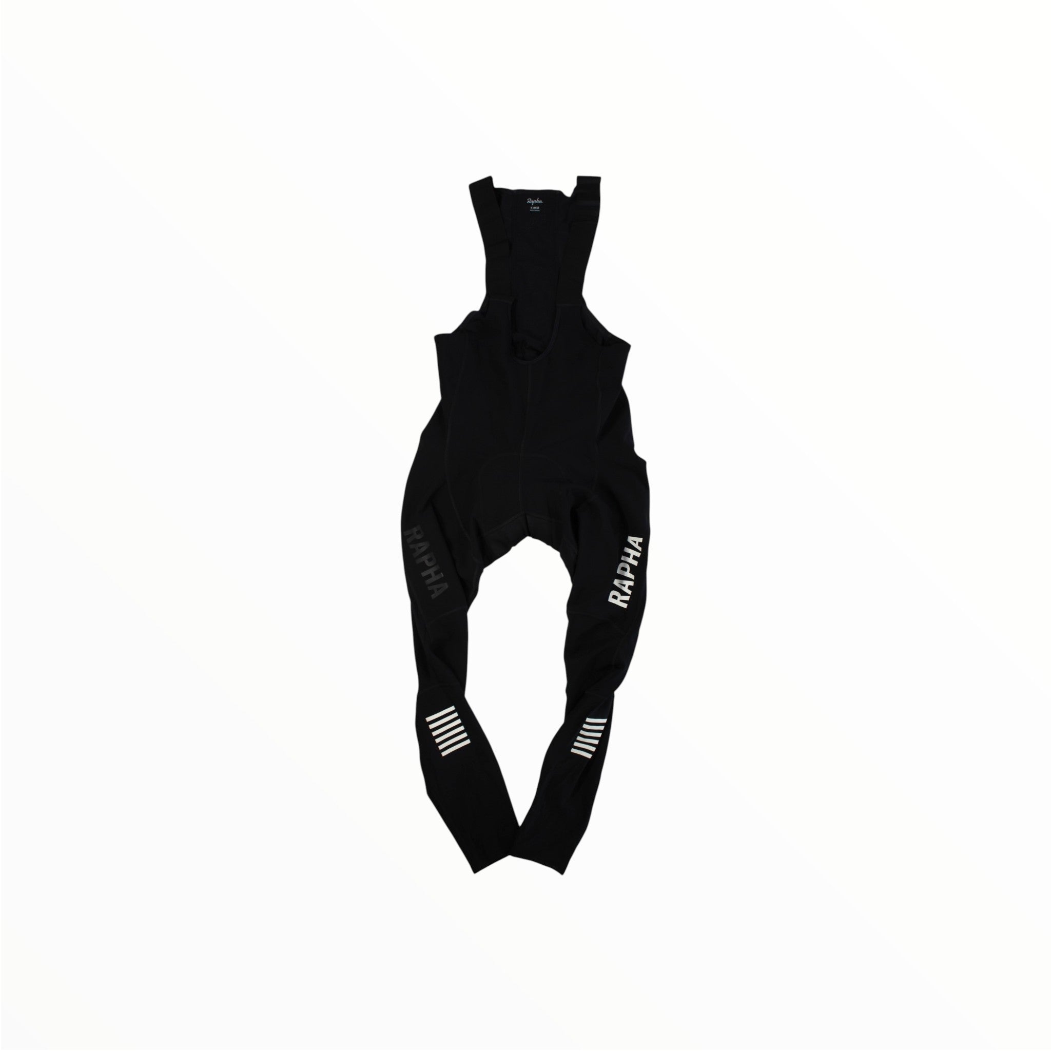 The Rapha Men’s Pro Team Winter Tights with Pad II are premium cycling tights from Rapha, featuring RAPHA branding in white on both legs and white horizontal stripes on the left calf. Designed as essential winter cycling gear, they are displayed against a plain white background.