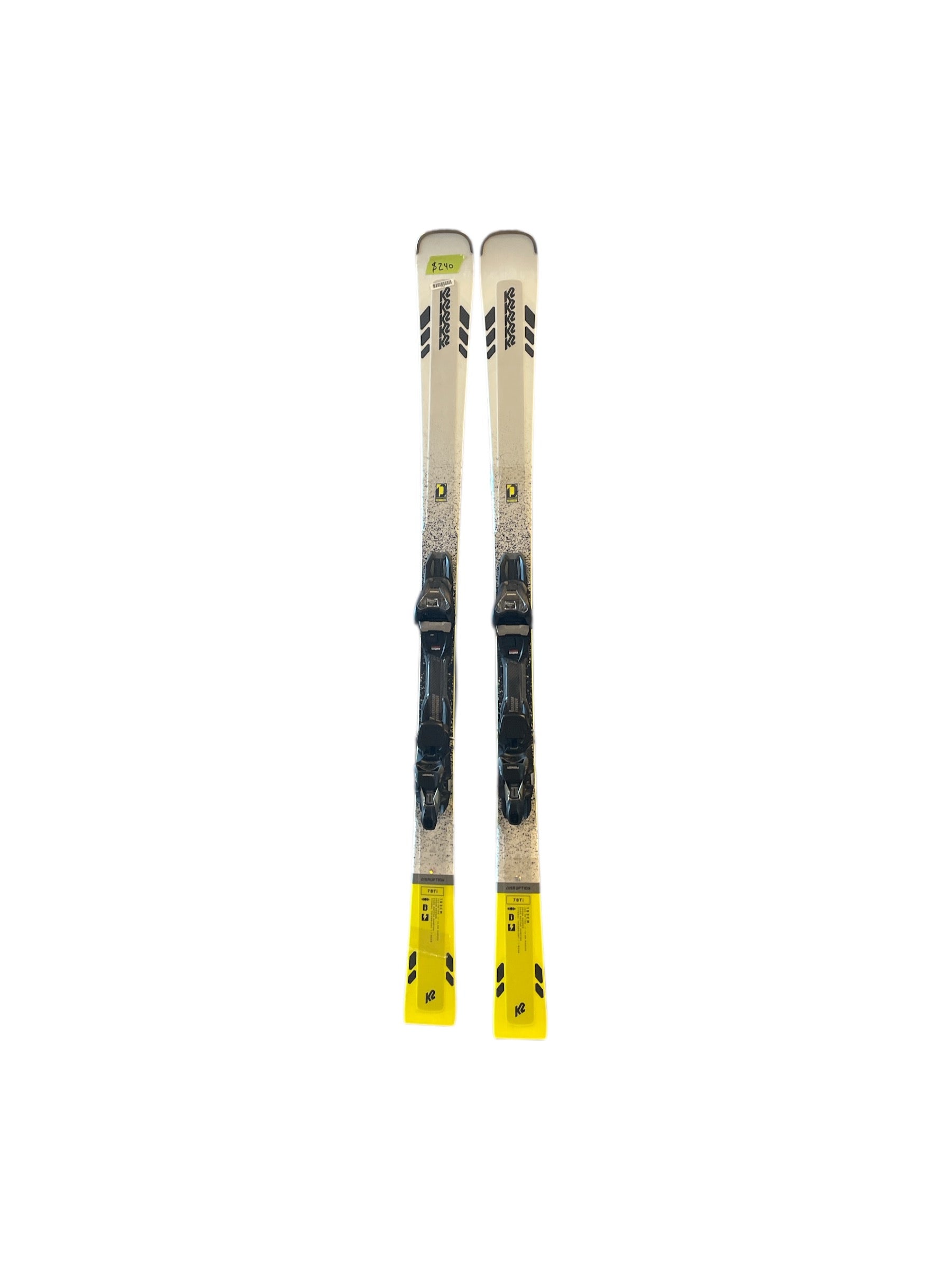 A pair of K2 Disruption 78Ti + Marker MXC12 TCx light quikclick skis in white, black, and yellow with titanium reinforcement are positioned side by side on a white background.