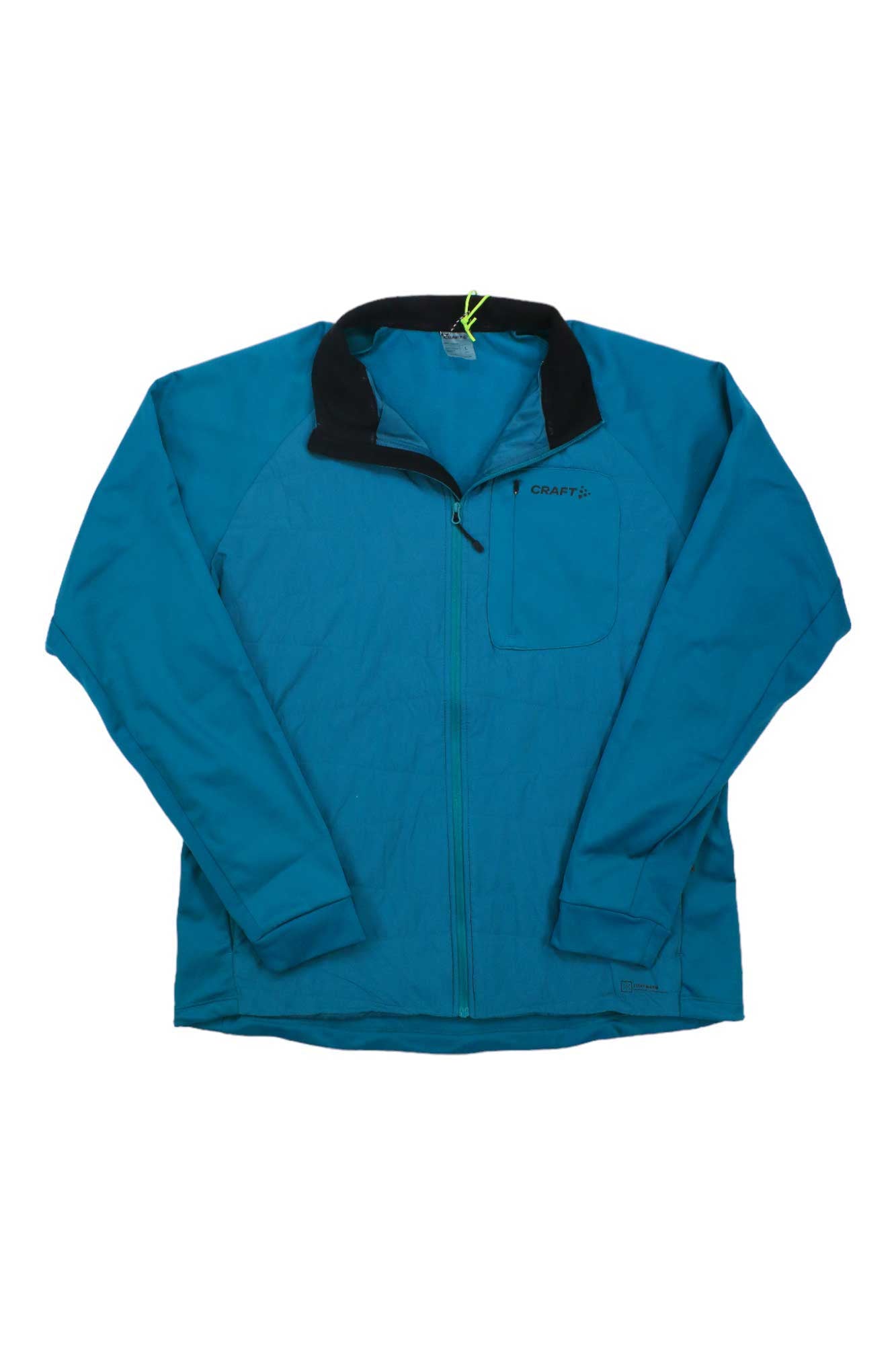 The Craft Sportswear Men's Core Nordic Training Insulated Jacket is blue with long sleeves, a black collar, and a zippered chest pocket, and is displayed flat on a white background.