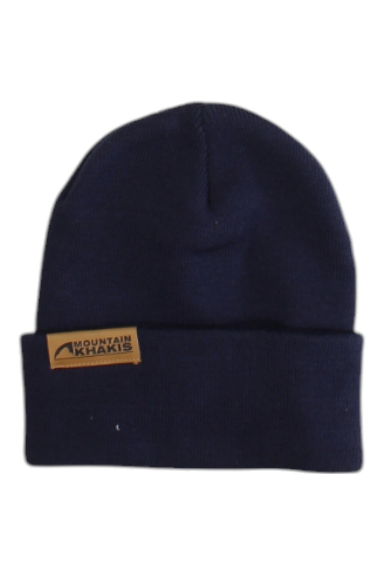 The Mountain Khakis Caliber Beanie is a navy blue knit outdoor hat with a folded brim and a brown logo patch on the front left side.