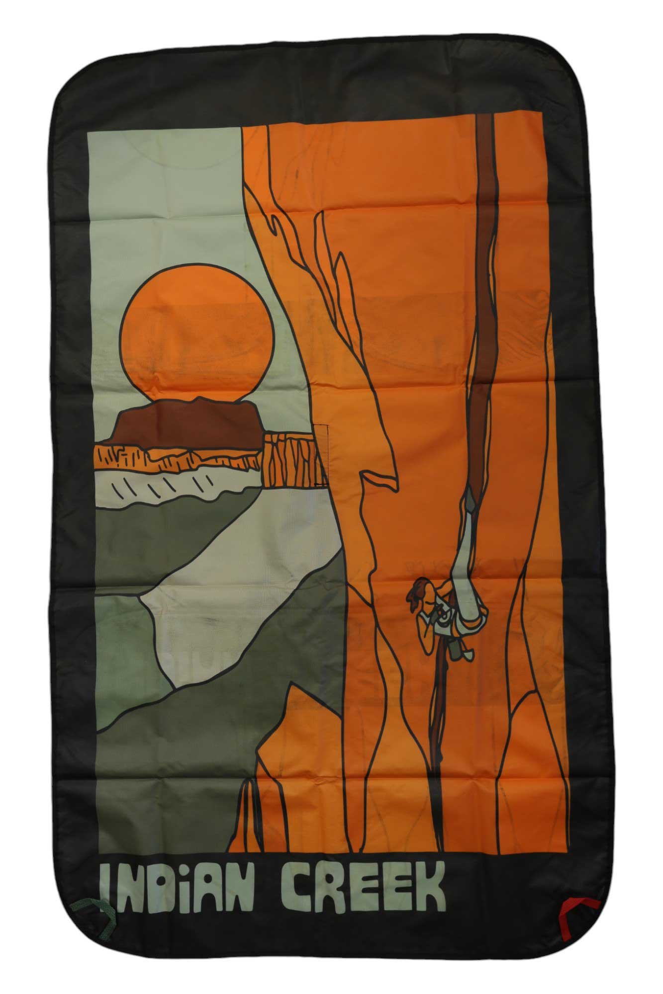 The Lacaida Rope Tarp features a stylized blanket design of a climber ascending an orange rock with the rope tarp below and the sun setting behind mesas. "INDIAN CREEK" is written at the bottom.