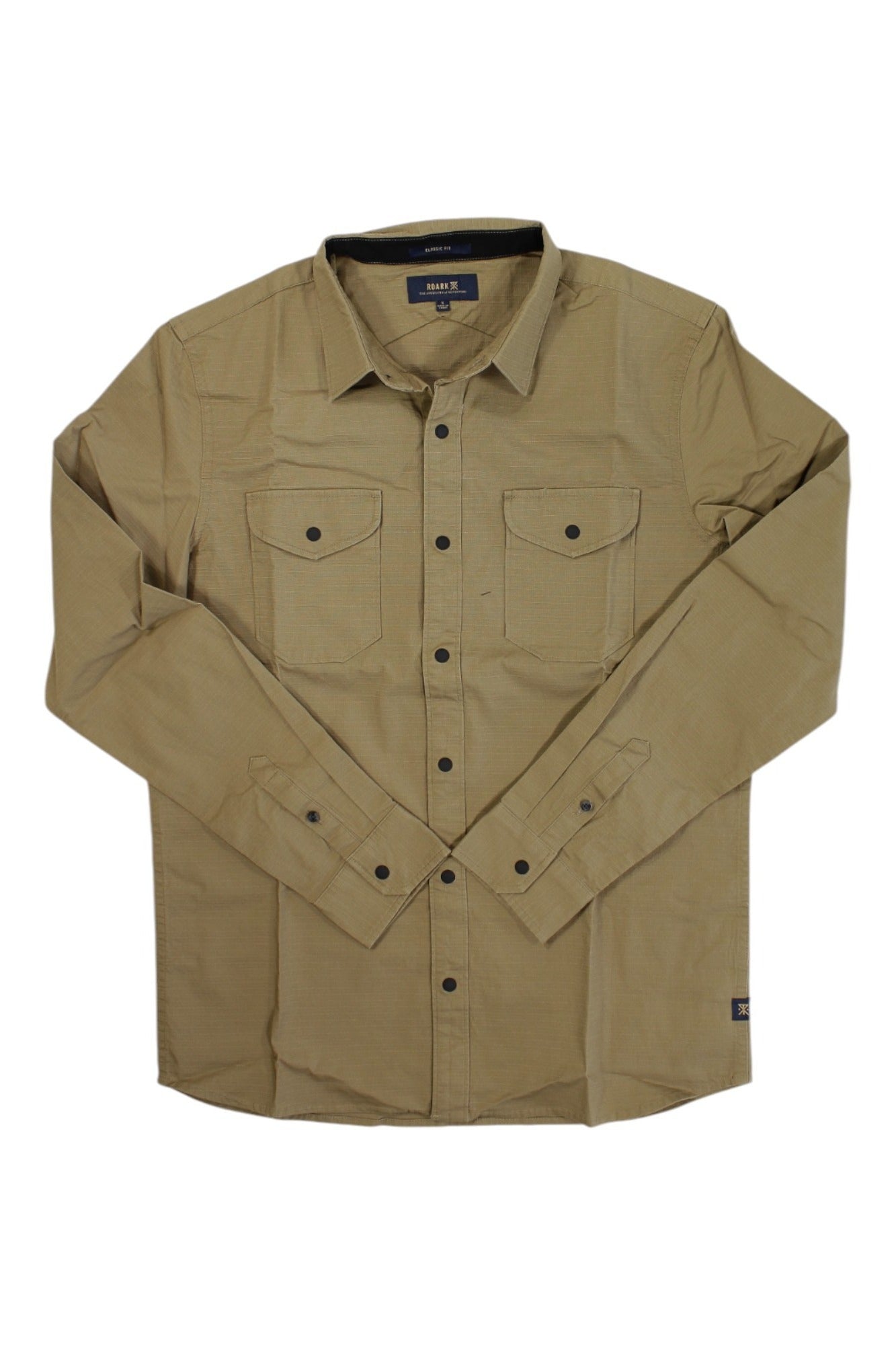 The Roark Mens Campover Shirt features long sleeves, light brown color, two chest pockets, and buttoned cuffs—laid flat on a white background. This versatile shirt is designed for outdoor comfort and everyday wear.