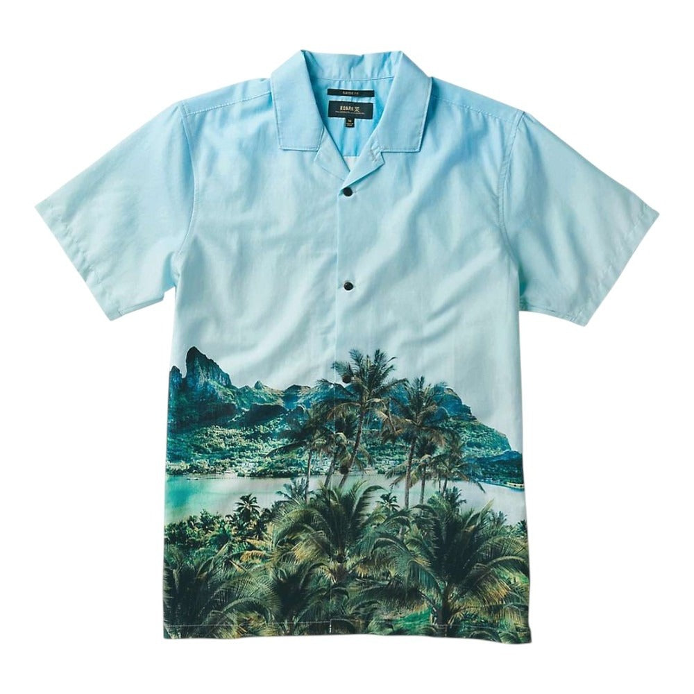 The Roark Mens Hinano Gonzo Otemanu Shirt is a light blue men's outdoor shirt featuring a quick-drying button-up design and a colorful tropical print of palm trees, mountains, and shoreline across the lower half.