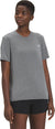 A woman wears The North Face Womens Wander SS Top, a gray hiking shirt, and black shorts. She stands against a plain white background, looking slightly to the side with a neutral expression.