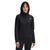 A woman stands facing the camera against a plain white background, wearing The North Face Women's TKA Glacier 1/4 Zip Top in black, made from recycled polyester fleece.