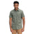 A man faces forward wearing The North Face Men's Baytrail Jacquard SS Shirt in sage green, featuring a subtle print, chest pocket, short sleeves, and classic button-up style. He pairs it with tan pants against a plain white background.