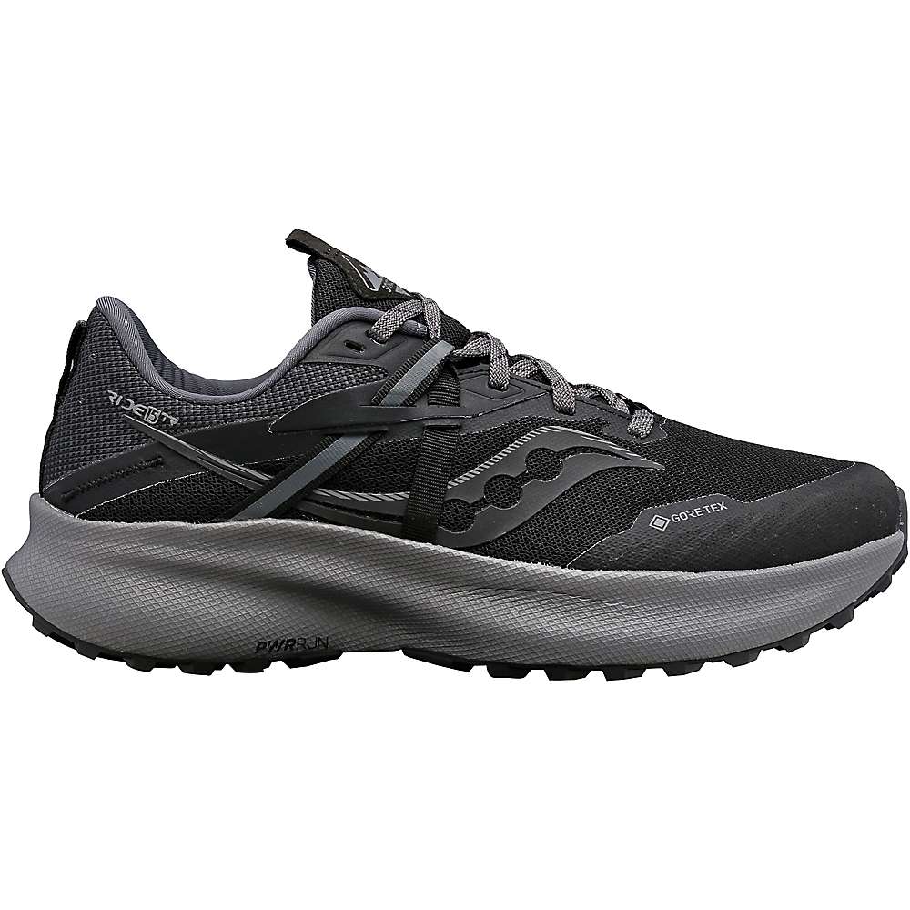 The Saucony Womens Ride 15 TR GTX Shoe features a black and gray design with a wavy logo, gray laces, and a thick textured sole. These GORE-TEX waterproof trail running shoes deliver peak performance on rugged terrain.
