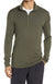 A man wearing the Icebreaker Mens 260 Tech LS Half Zip Top in olive green with a white undershirt and black pants, standing with one hand in his pocket.