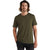 A man with wavy, shoulder-length brown hair and a beard is wearing an olive green Icebreaker Mens Tech Lite II SS Tee and black pants, standing against a plain white background.