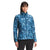 A woman stands facing forward, hands at her sides, wearing The North Face Women's Printed ThermoBall Eco Jacket—a blue patterned, quilted jacket with a front zipper—against a plain white background.