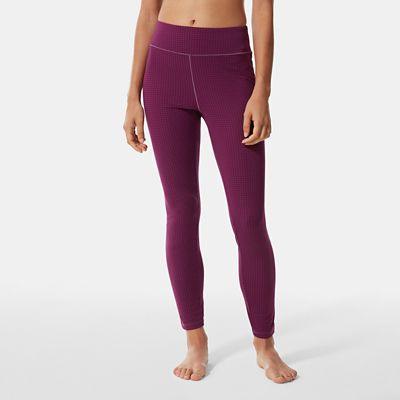 A person stands barefoot, wearing The North Face Womens DotKnit Tight in high-waisted, ribbed purple with a matching cropped top, shown from shoulders to feet against a plain light gray background—perfect athleisure style.