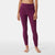 A person stands barefoot, wearing The North Face Womens DotKnit Tight in high-waisted, ribbed purple with a matching cropped top, shown from shoulders to feet against a plain light gray background—perfect athleisure style.