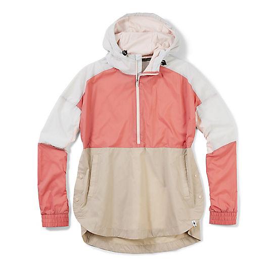 The Smartwool Womens Merino Sport Ultra Light Anorak is a color-blocked windbreaker with a half-zip front, featuring white shoulders and hood, light pink chest and sleeves, plus a beige lower section and cuffs.