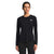 A woman with dark hair pulled back and a neutral expression faces forward, wearing The North Face Women's Elevation LS Top in black, made from recycled polyester with moisture-wicking and a white logo on the left chest.