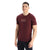 A young man with short dark hair smiles and stands, looking slightly to the side against a white background, wearing the Icebreaker Mens Tech Lite II SS Tee - Mountain Geology featuring a mountain graphic and "icebreaker" on the chest.