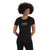 A woman with curly hair wears the Icebreaker Womens Tech Lite II SS Tee - Mountain Geology, a fitted black merino wool shirt with a colorful striped mountain motif and icebreaker logo, offering natural odor-resistance.