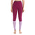 A barefoot person wears Icebreaker Women's 125 Zoneknit Legging—high-waisted, two-tone Merino wool with a magenta upper and light purple lower legs. The waistband says "icebreaker." Their face is not shown.