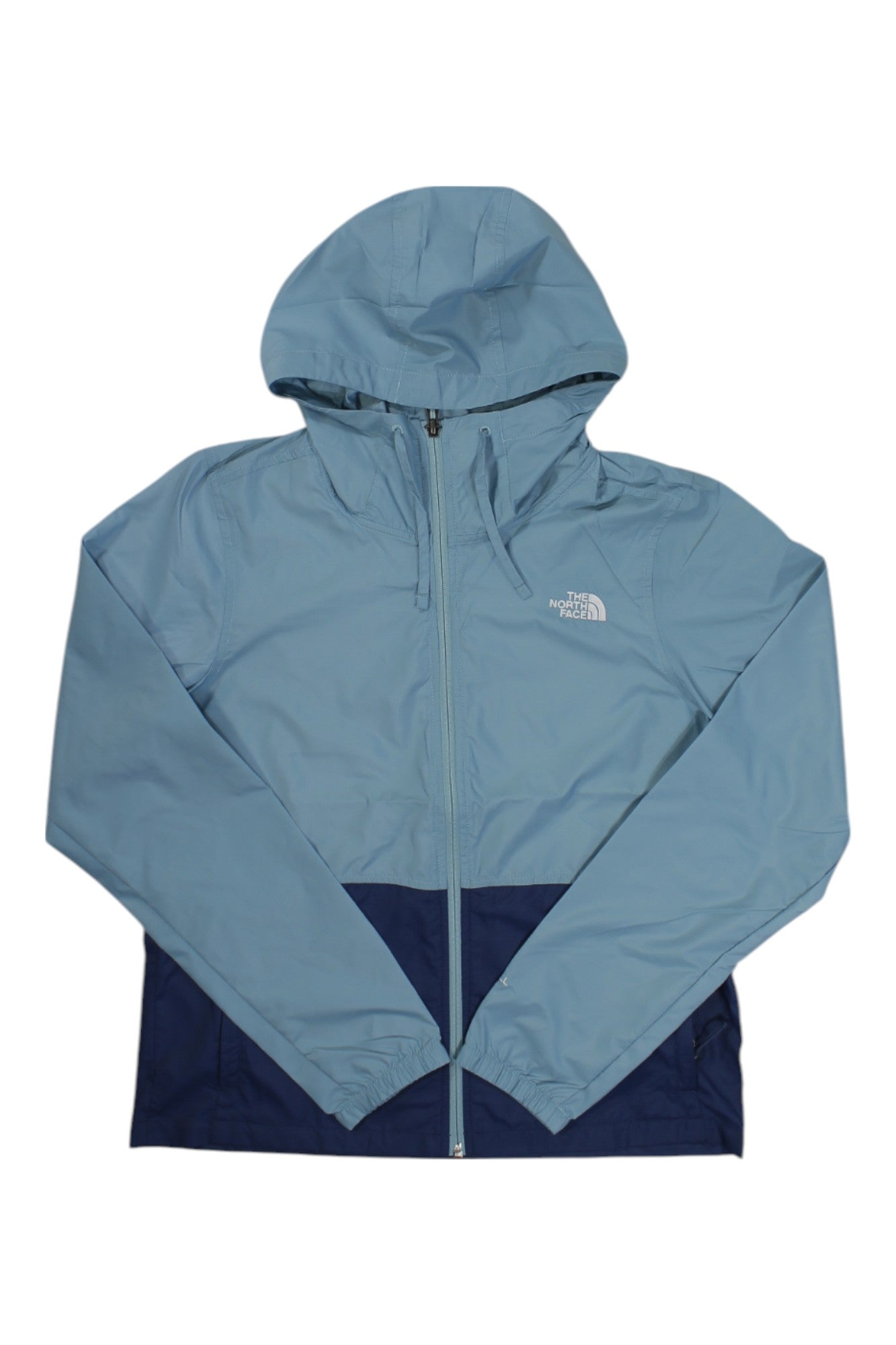 The North Face Women's Cyclone 3 Jacket in light blue with a dark blue lower section and left chest logo. This wind-resistant jacket has a front zipper and long sleeves, making it an ideal lightweight layer for breezy days.
