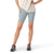 Wearing a white shirt, Smartwool Women's Active Biker Short in light blue with a high-rise waist and side pocket, and black sneakers with pink laces, a person stands with one hand on their hip against a plain white background.