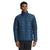 A man stands facing forward in The North Face Men's ThermoBall Eco Jacket (blue, recycled nylon, insulated, high collar) and black pants, with a neutral expression against a plain white background.