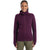 A person wearing the Icebreaker Women's Merino ZoneKnit Explore LS Zip Hoodie in dark purple, featuring a high collar and thumb holes, stands facing the camera, smiling with hands relaxed at their sides.