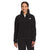 A person stands smiling in a black The North Face Womens Alpine Polartec 200 1/4 Zip Top and black pants, against a plain white background.