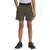 A person wearing olive green The North Face Boys' On The Trail Short made from recycled polyester, a gray t-shirt tucked in, and black athletic shoes stands with hands in pockets against a plain white background.
