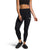A woman stands against a white background wearing a black crop top, The North Face Women’s Fd Pro 160 Tight with FlashDry-Pro moisture-wicking technology, and black slip-on shoes.