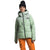 A person in a light green The North Face Womens Corefire Down Windstopper Jacket with 550 fill goose down, orange pants, and a black beanie stands against a white background. Both jacket and pants display The North Face logo.