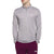 A man stands with his hands in his pockets against a white background, wearing a light gray The North Face Mens Elevation 1/4 Zip Top and maroon North Face pants.