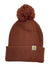 The Carhartt Womens Knit Pom Pom Cuffed Beanie is a brown knit hat with a large pom-pom on top, a folded brim, and a small Carhartt logo patch.