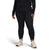 A person stands against a plain white background, wearing a black long-sleeve top, The North Face Womens Plus Fd Pro 160 Tight leggings made from recycled polyester, and cream sneakers. Their hands rest relaxed at their sides.