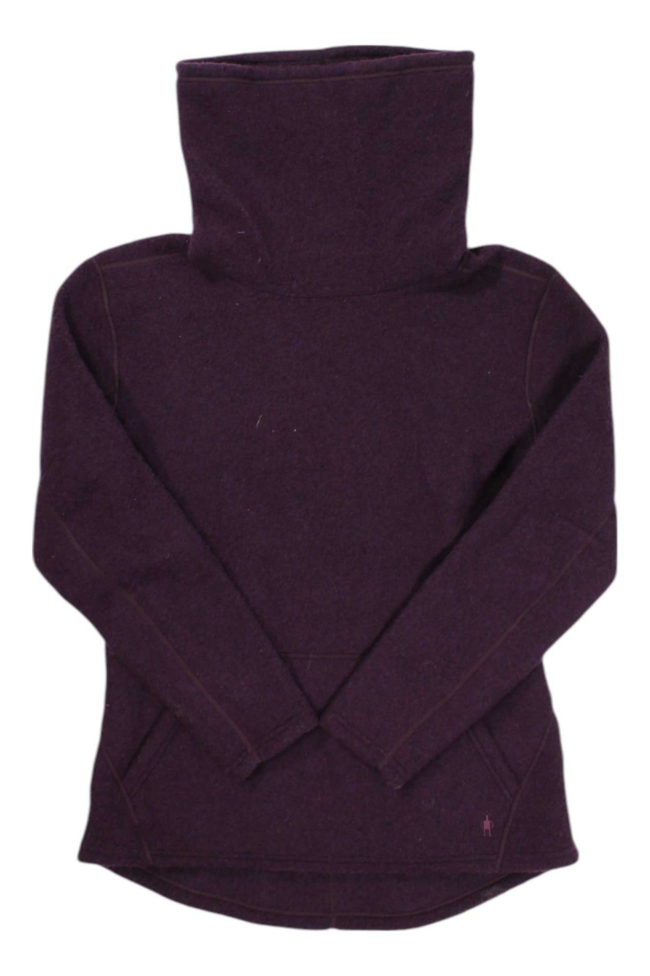The Smartwool Women's Hudson Trail Fleece Pullover is a long-sleeve, high-neck sweater in dark purple with crossed wrists. Made from recycled wool fleece, it features visible seams and a rounded hem for a cozy, stylish look.