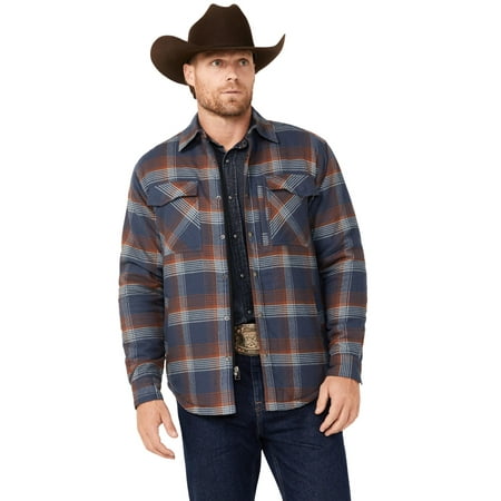 A man wearing the Dakota Grizzly Men's Quilted Tobias Ripstop Flannel in navy plaid (large), blue jeans, a brown cowboy hat, and a large belt buckle stands turned slightly to the side with a neutral expression.