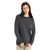 A woman with long dark hair and a neutral expression models the Icebreaker Womens Nova Sweater Sweatshirt in dark gray with light beige pants, standing against a plain white background, arms relaxed by her sides.