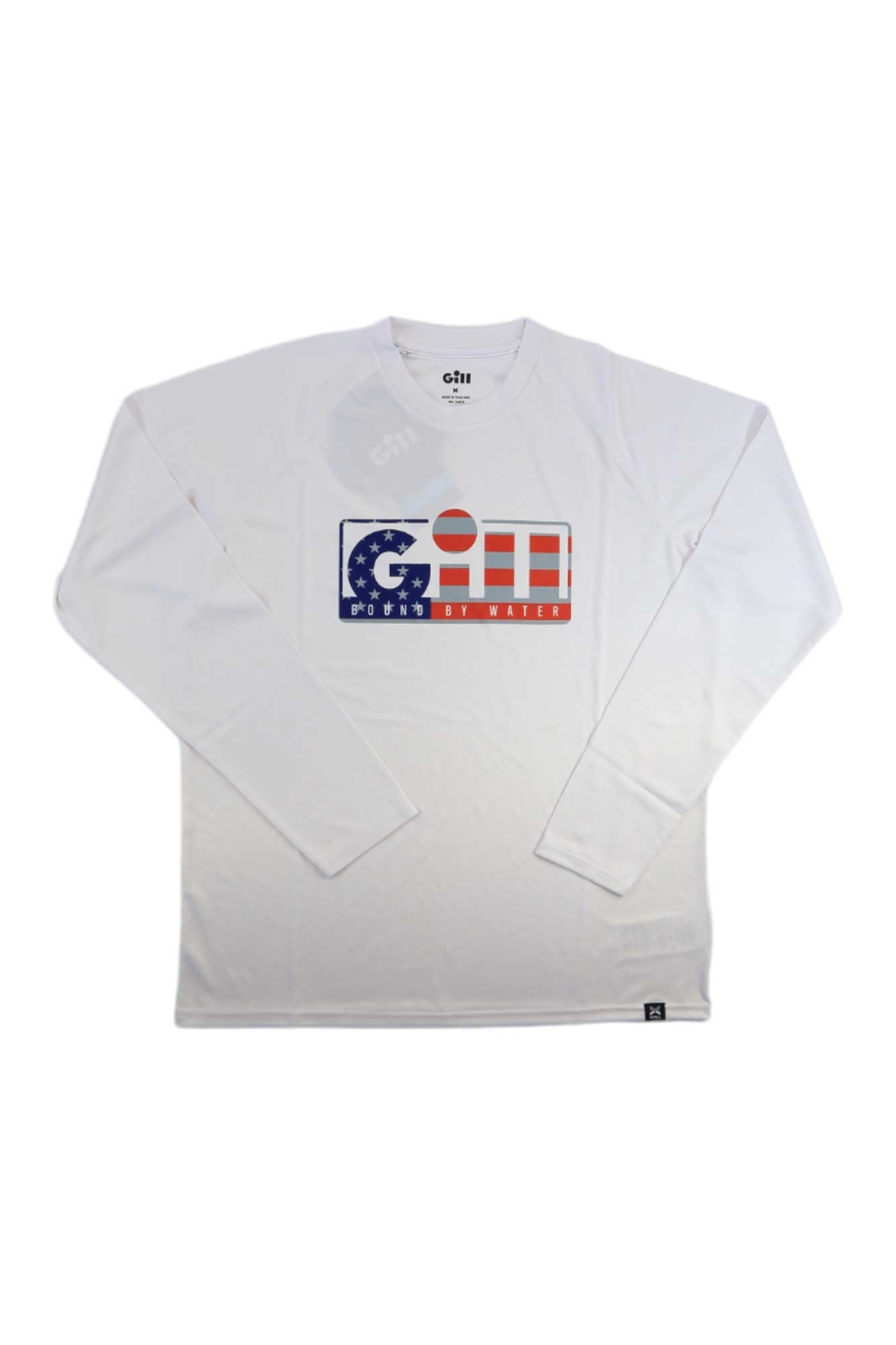 The Gill Mens Xpel Tec LS Top is a white long-sleeve fishing shirt with "Gill," an American flag graphic, and "roots by water" on the front. It offers sun protection and moisture-wicking comfort for outdoor activities.
