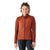 A woman with curly hair in a bun smiles while wearing the Smartwool Womens Intraknit Active Full Zip Jacket in rust and black leggings, standing against a plain white background.