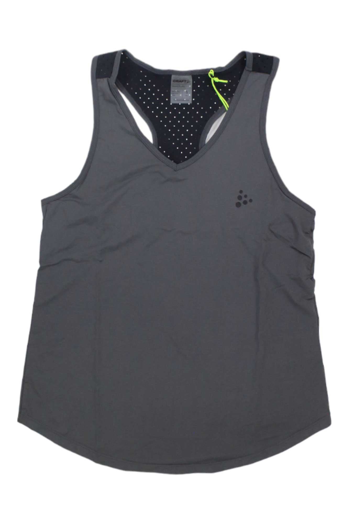 The Craft Sportswear Women's Adv Charge Perforated Singlet is a sleeveless dark gray racerback gym top with a small left chest logo, black inner lining with white polka dots, and a neon green loop inside the neckline.