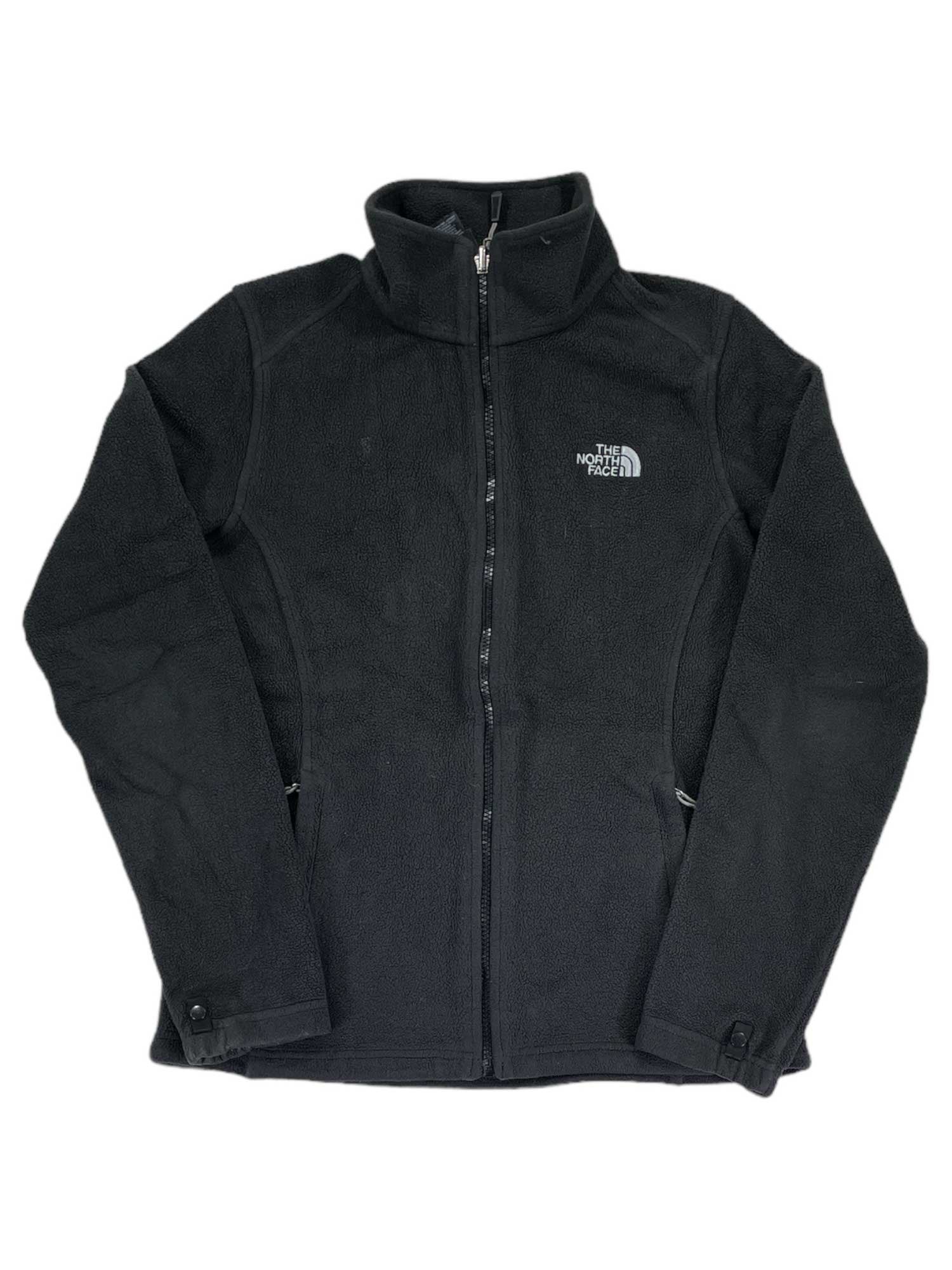A black Khumbu Fleece Jacket with a full front zipper, high collar, and zippered pockets. Made from quick-drying polyester midweight fleece with a white embroidered North Face logo on the left chest.