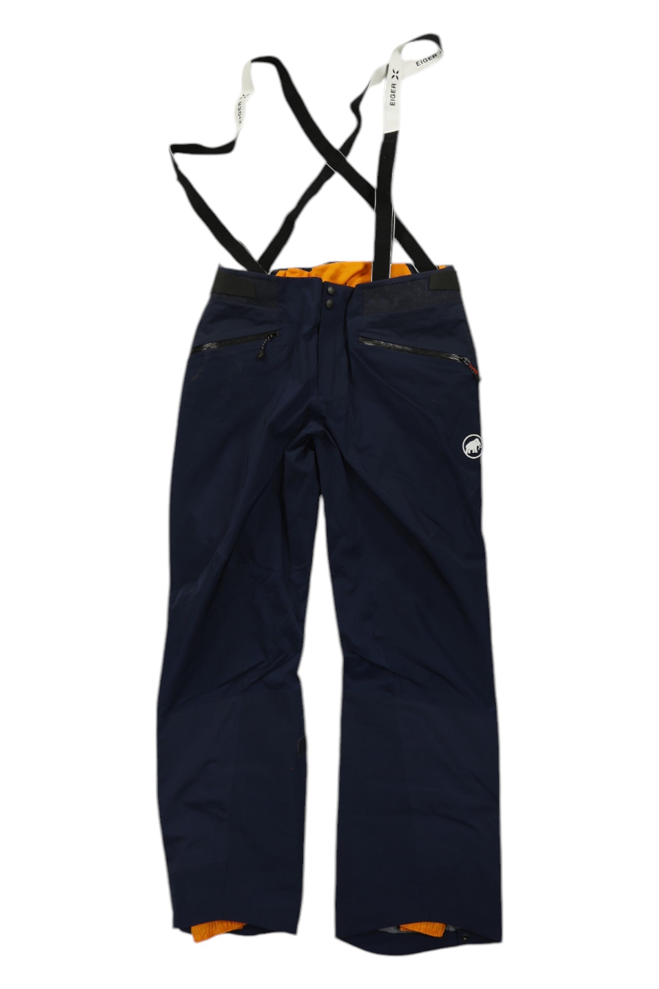 The Mammut Mens Nordwand Pro HS Pant features dark blue hardshell fabric, black adjustable suspenders, orange lining at the waistband and cuffs, zippered pockets, and a small white logo on the left thigh—perfect for alpine adventures.