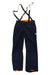 The Mammut Mens Nordwand Pro HS Pant features dark blue hardshell fabric, black adjustable suspenders, orange lining at the waistband and cuffs, zippered pockets, and a small white logo on the left thigh—perfect for alpine adventures.