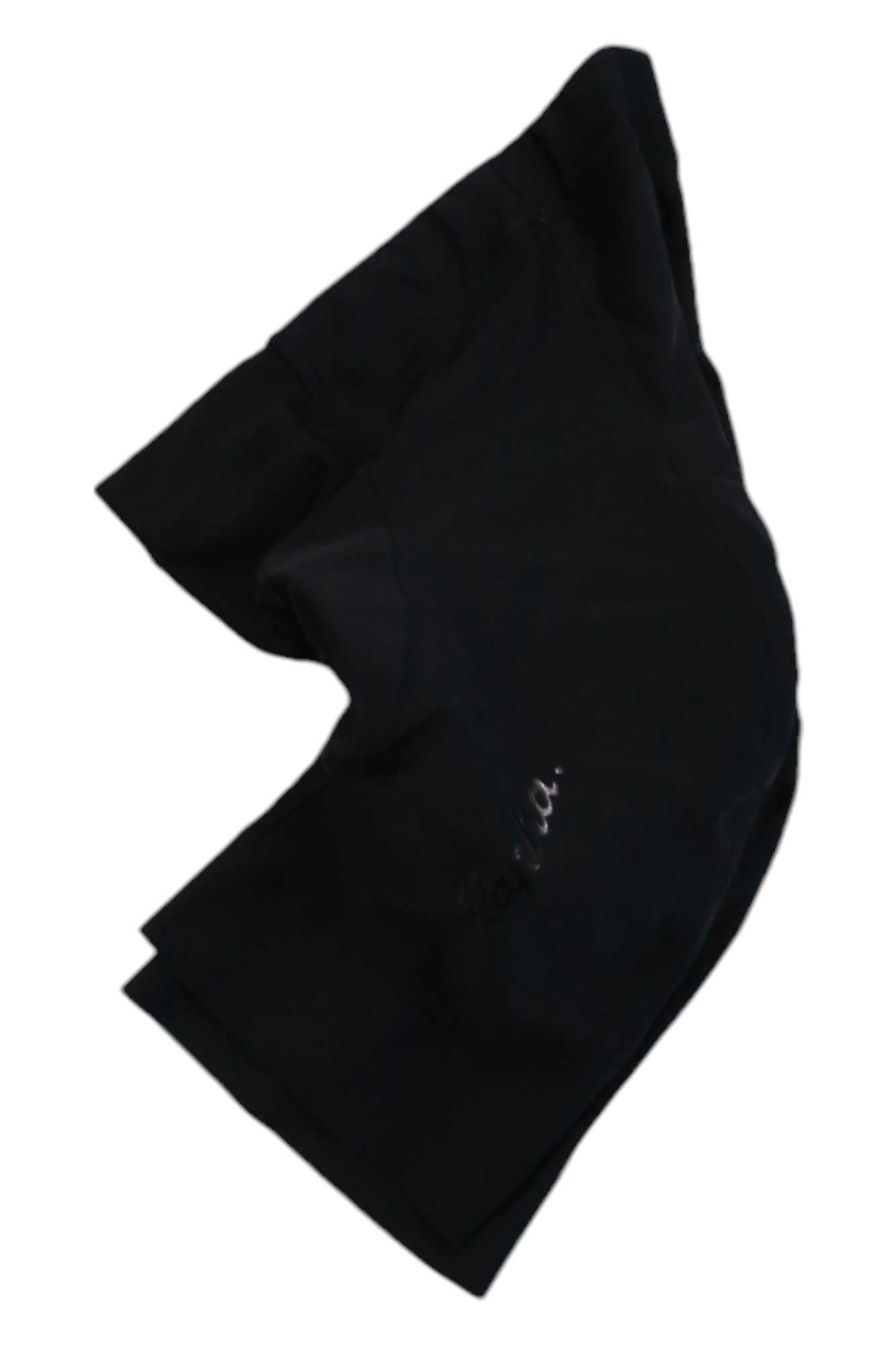 A pair of black Rapha Mens Core Shorts laid flat on a white background, slightly folded, with a small logo visible on one leg—cycling bib shorts designed for comfort and performance.