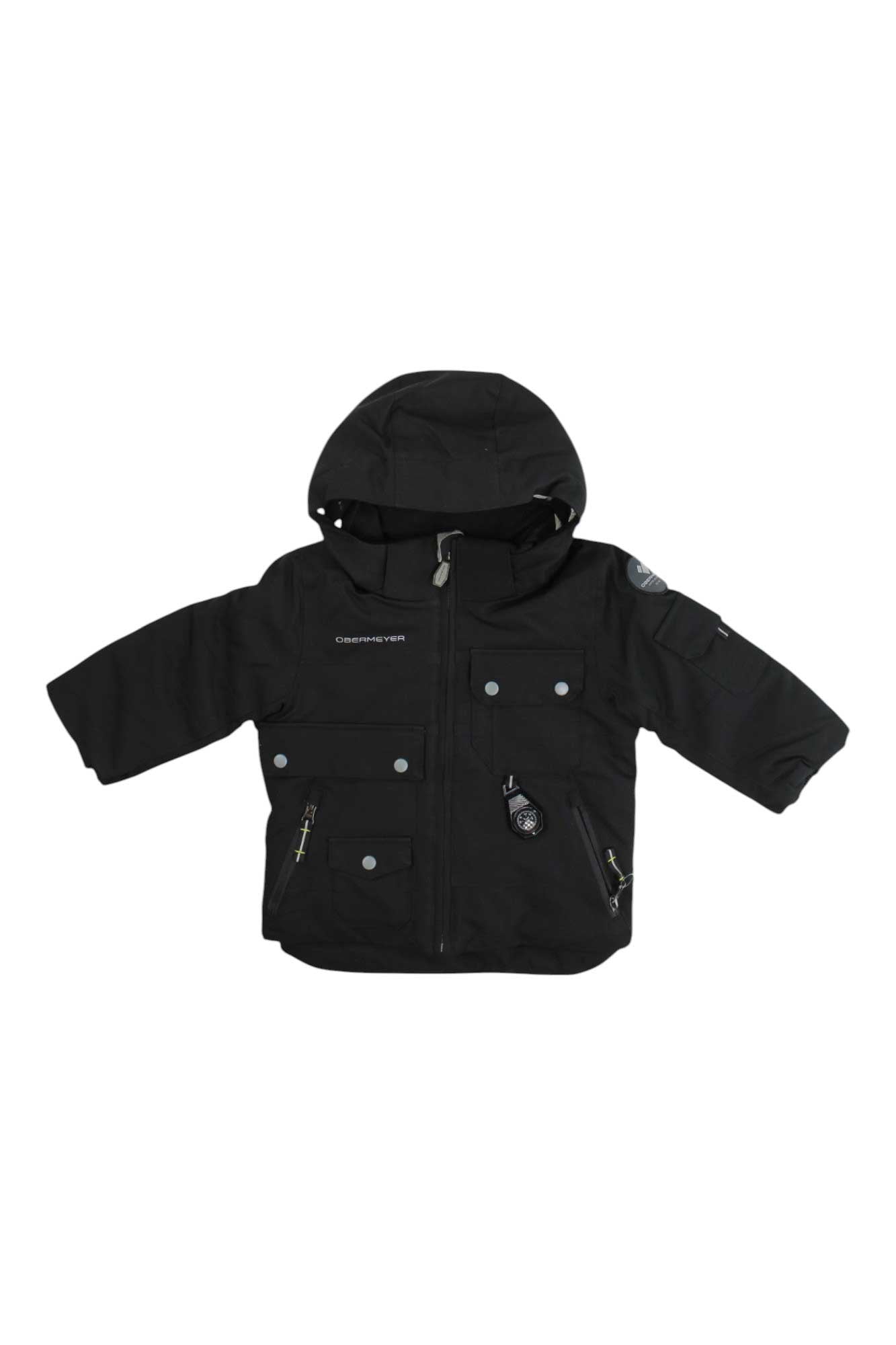 The Obermeyer Boys Nebula Jacket is a black, insulated winter jacket for boys featuring a hood, front zipper, multiple pockets with buttons and zippers, and small chest and sleeve logos. Displayed on a white background.