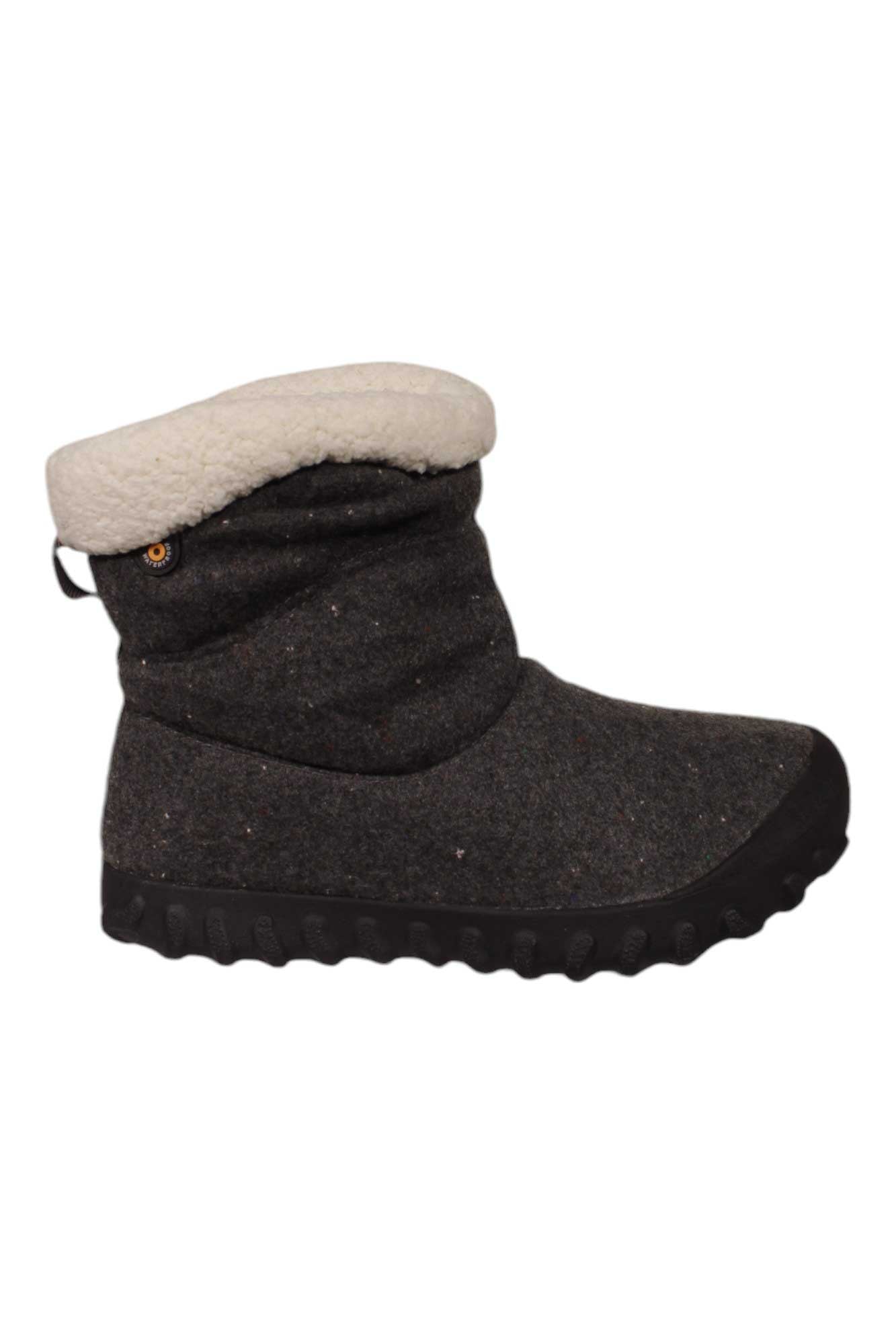 The Bogs Women's B MOC II Boot is a dark gray winter boot featuring a black rubber sole, light fleece lining at the top, and insulation for warmth. It has a relaxed, slightly slouched shape for comfort.