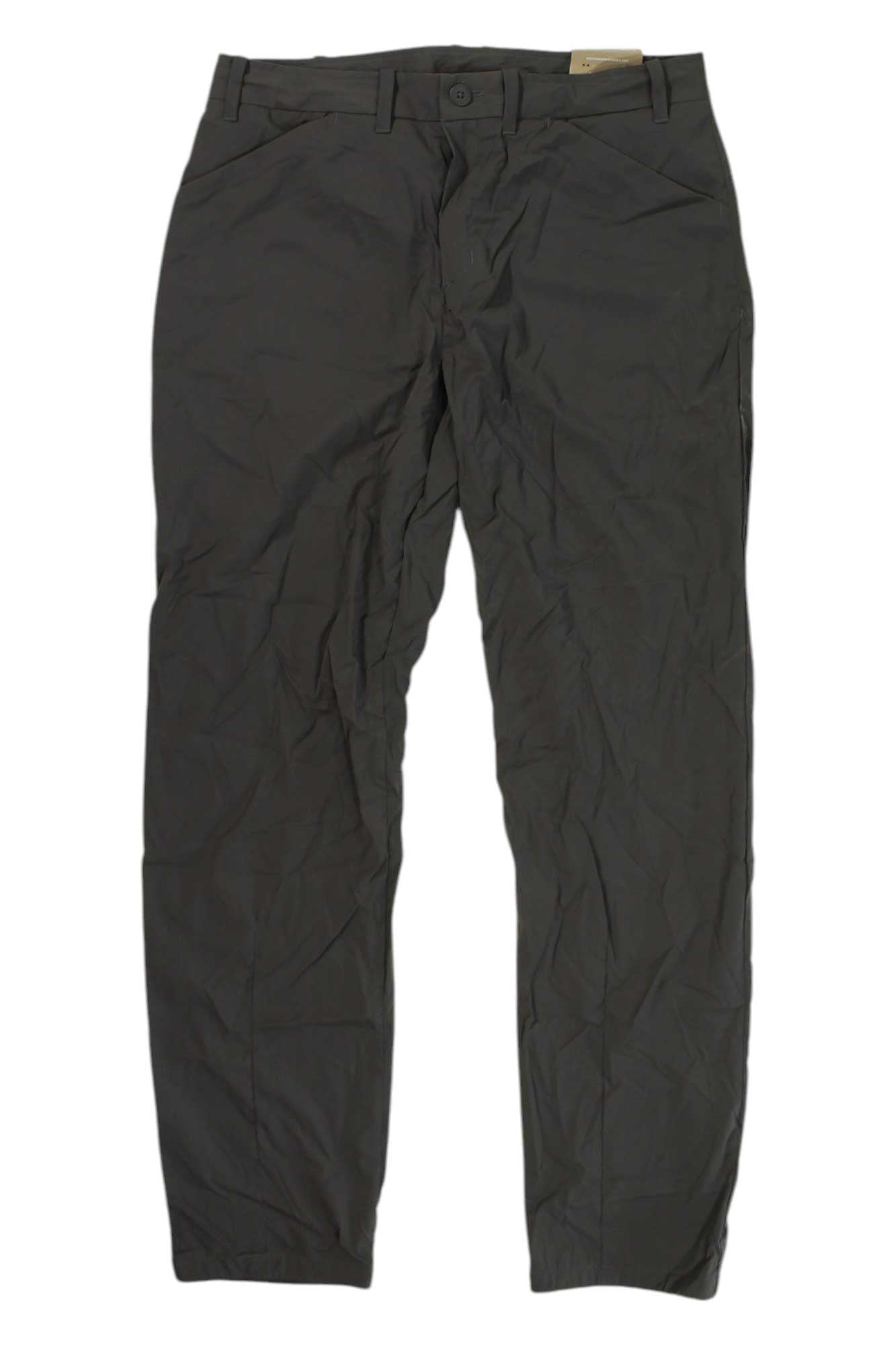 The Houdini Womens Wadi Pant is a pair of dark gray, lightweight hiking pants with belt loops, button closure, and front pockets—ideal for outdoor adventures.