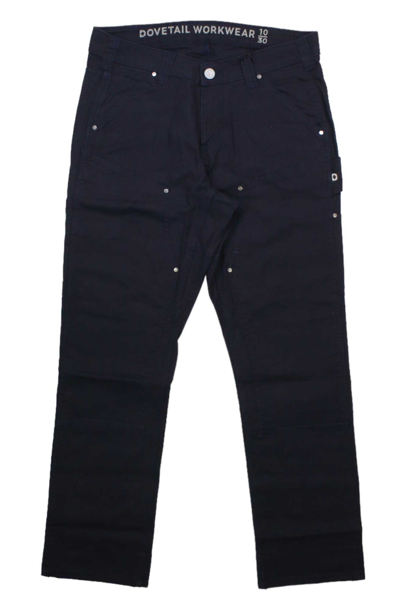 The Dovetail Women's Anna Taskpant is a black work pant featuring silver rivets and button, functional front and back pockets, and “Dovetail Workwear” on the inner waistband.