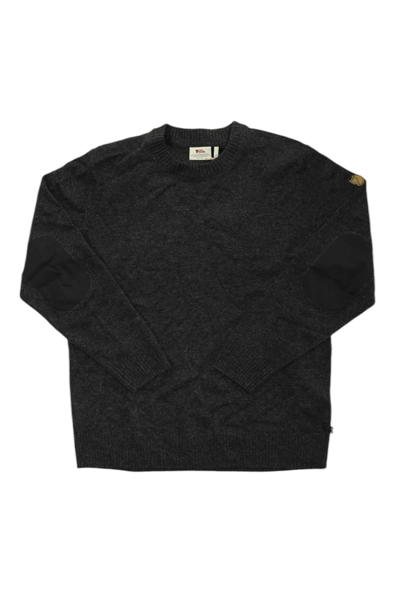The Fjallraven Mens Ovik Round Neck Sweater is a dark gray G-1000 reinforced knit with black elbow patches, a ribbed crew neck, and a small tan label on the left shoulder, shown laid flat on a white background.