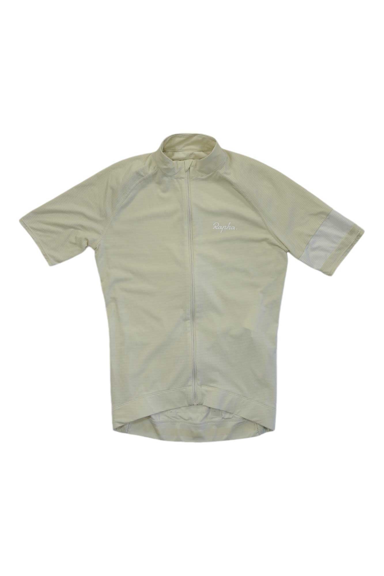 The Rapha Mens Core Lightweight Jersey in light beige features short sleeves, a full front zipper, and a subtle chest logo. Designed for warm-weather rides, this breathable jersey is displayed on a white background.