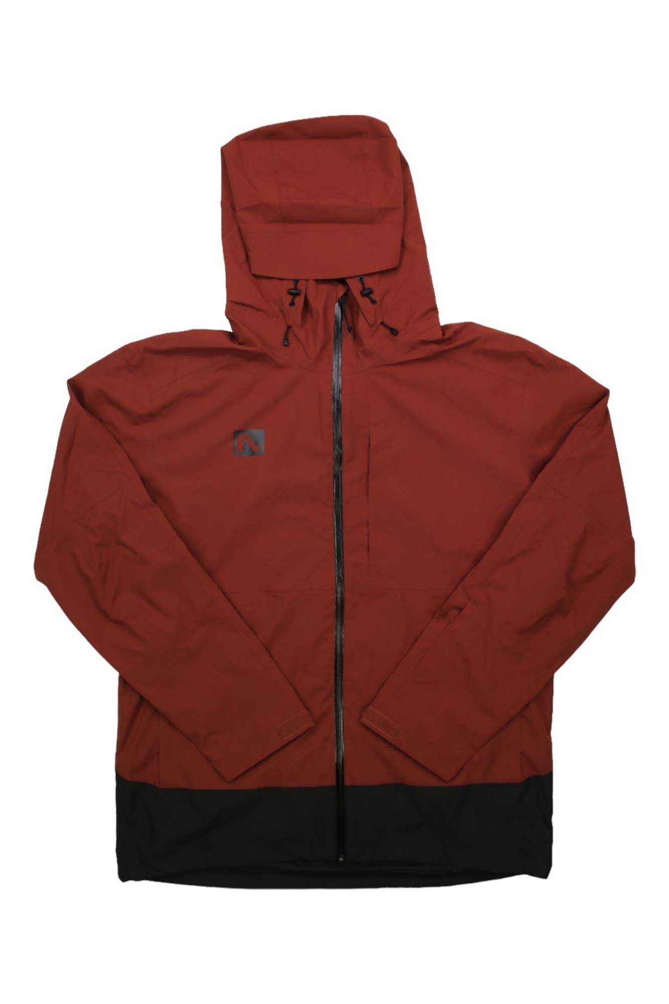 A rust-red Flylow Mens Dante Jacket with a black hem, front zipper, and small left chest logo. This technical hardshell jacket has a waterproof breathable membrane and is shown laid flat on a white background.