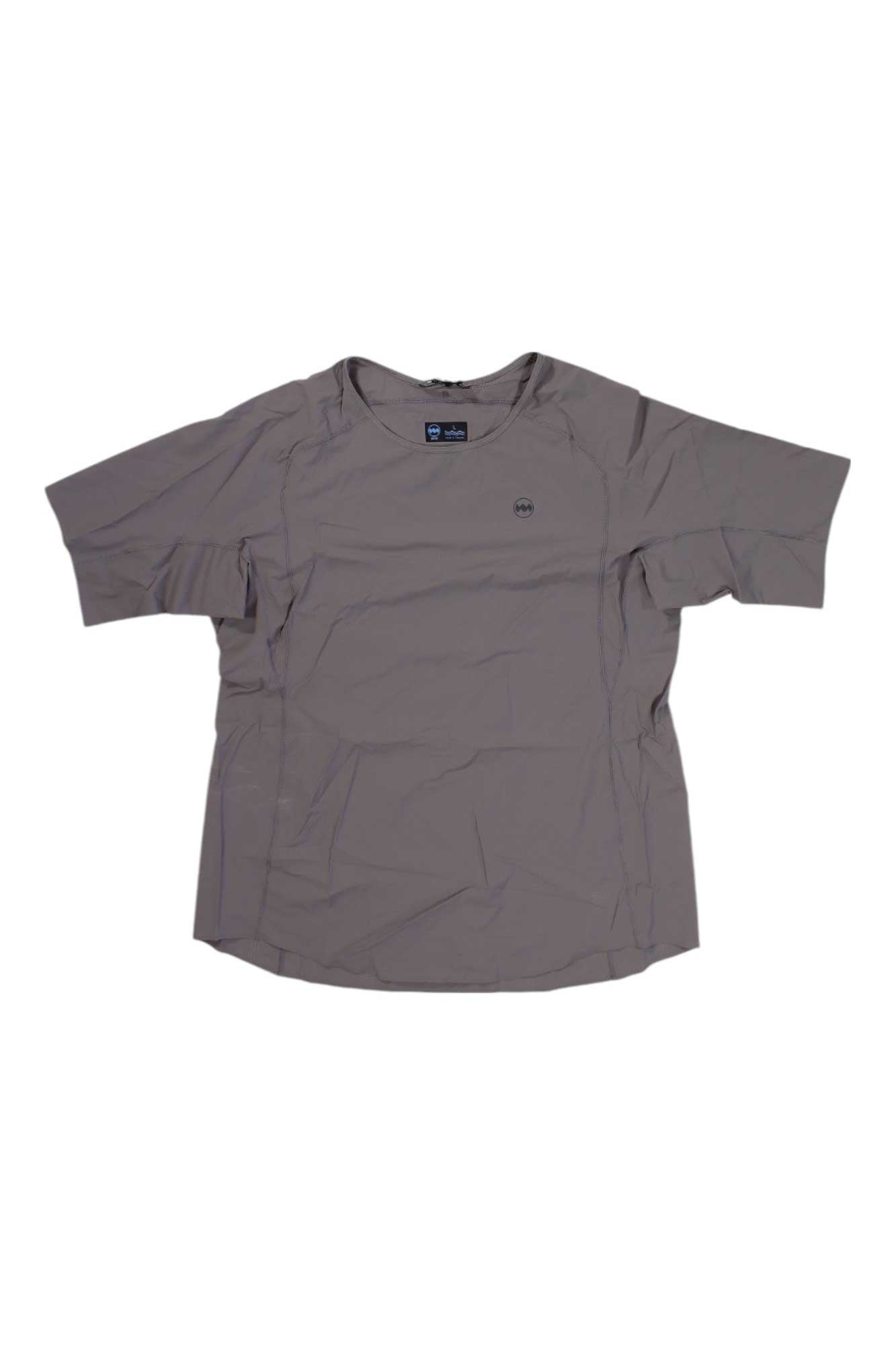 The Janji Womens AFO Vent SS Tee, a light gray, short-sleeved moisture-wicking shirt with a small chest logo, is laid flat on a white background. The fabric has some visible wrinkles.